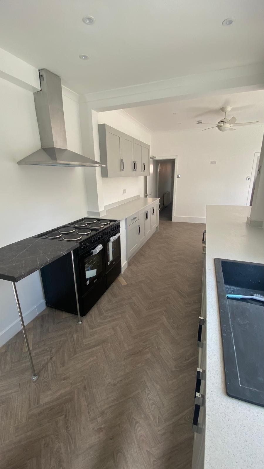 Roots’ renovated kitchen with light cabinets and a spacious cooking area